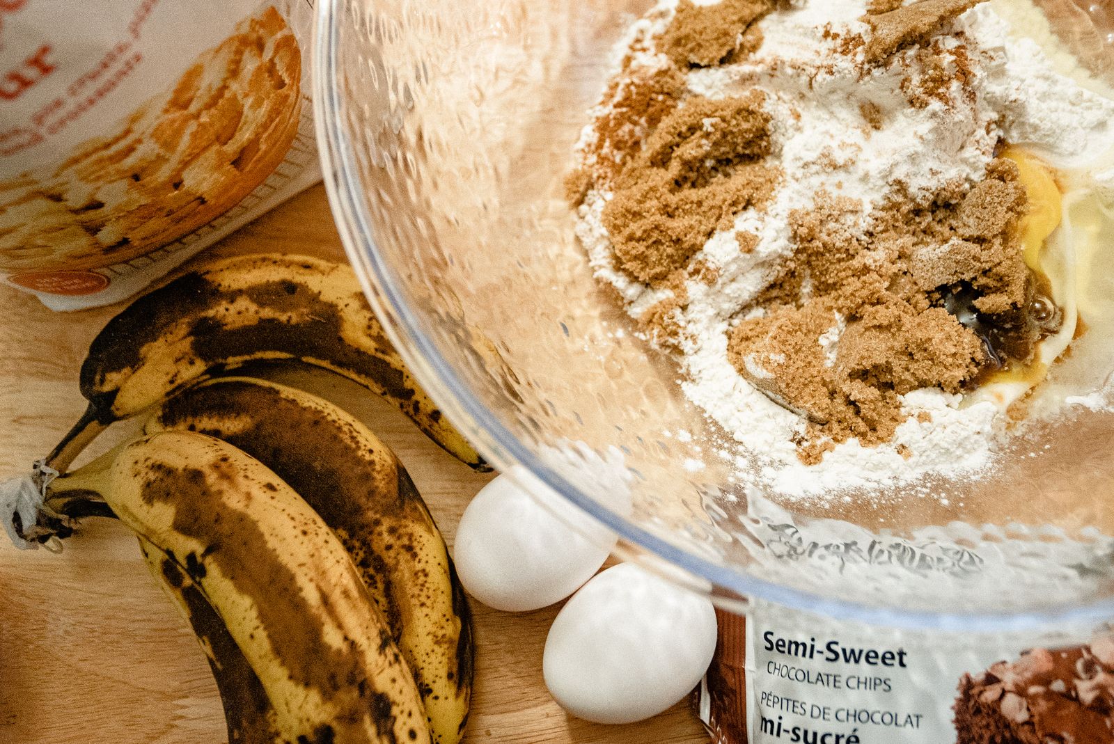 Preparing to bake banana bread with flour, ripe bananas and eggs
