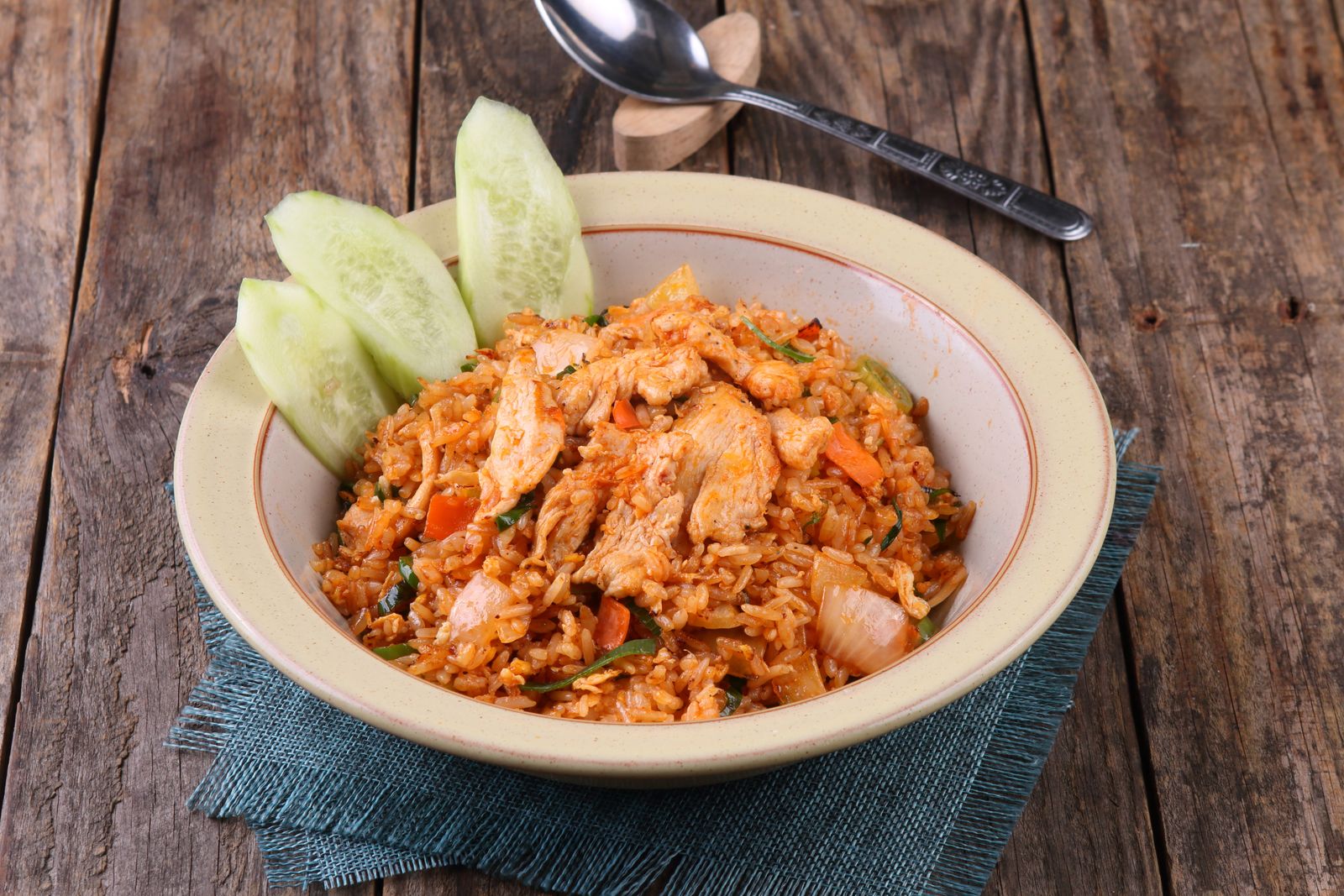 Savory chicken fried rice served with fresh cucumber slices