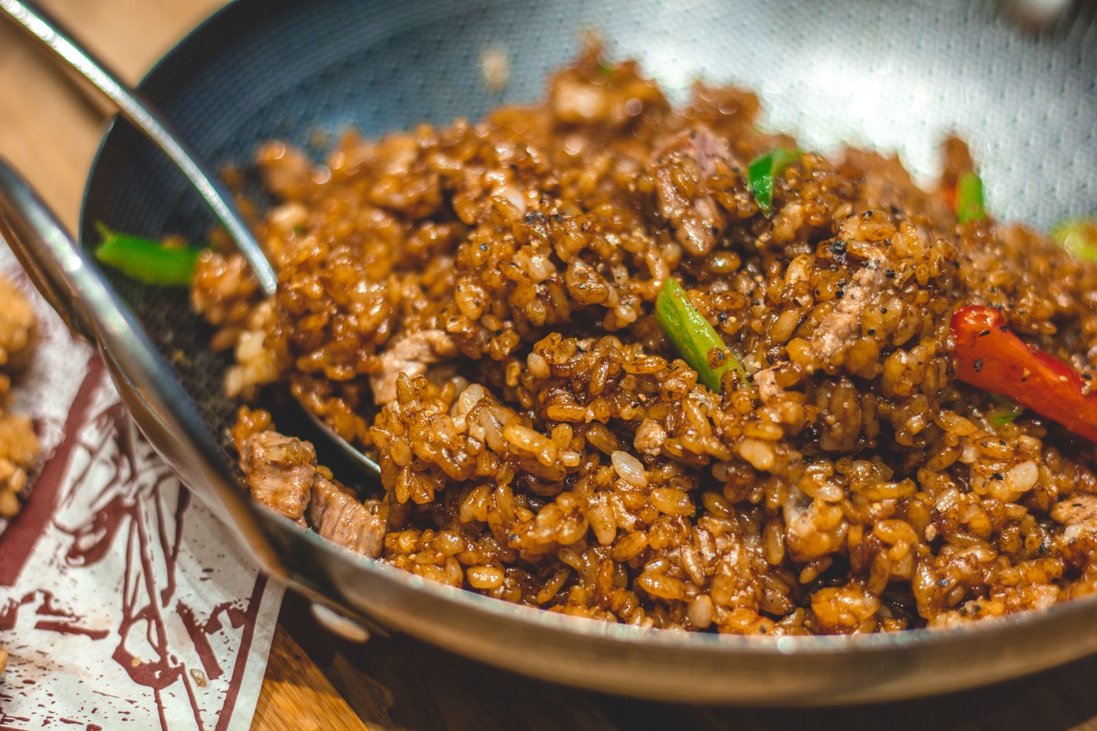 Close-up of fried rice with vegetables and spices sauteed in a wok