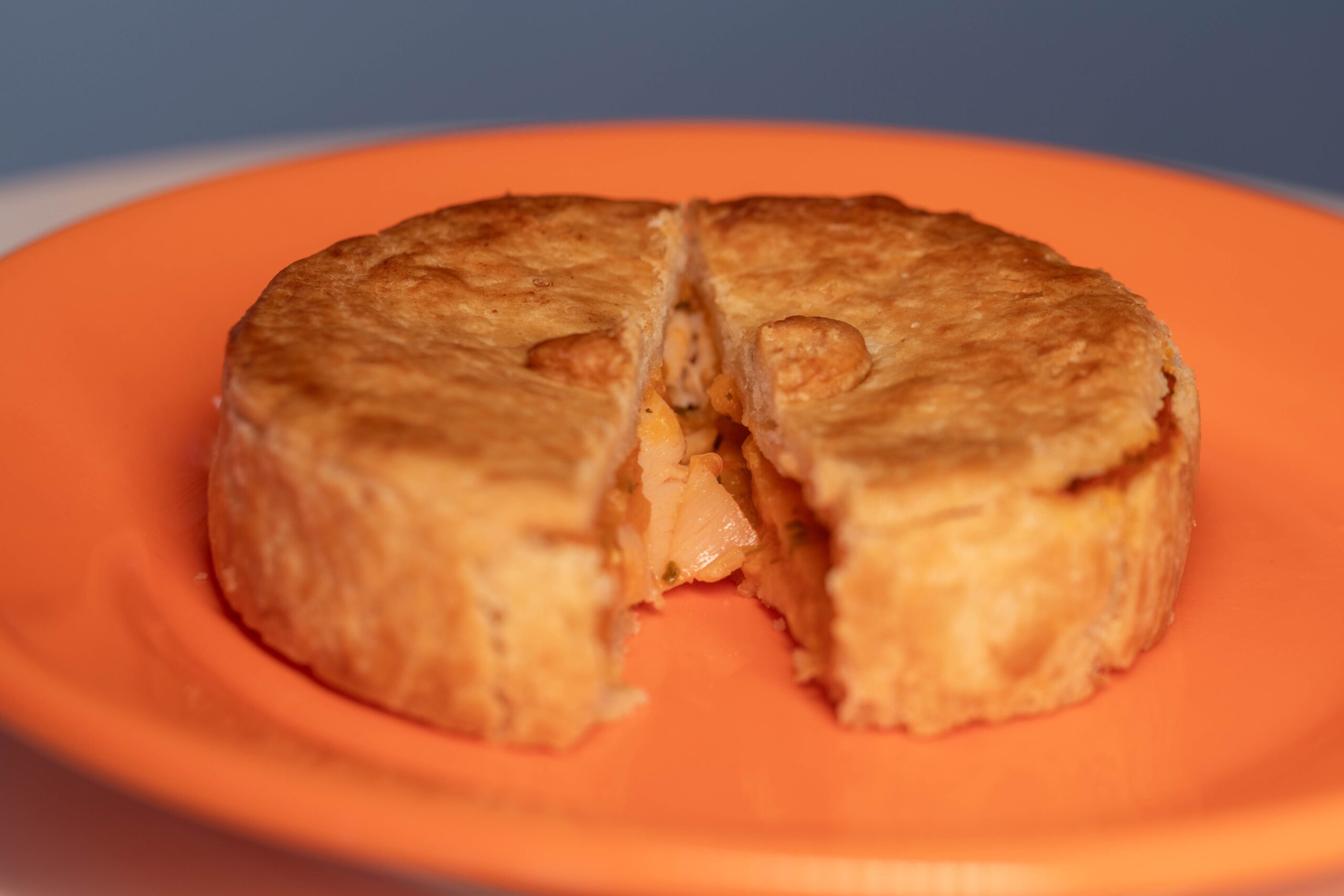 Classic chicken pot pie with a golden baked crust, sliced open to show the filling