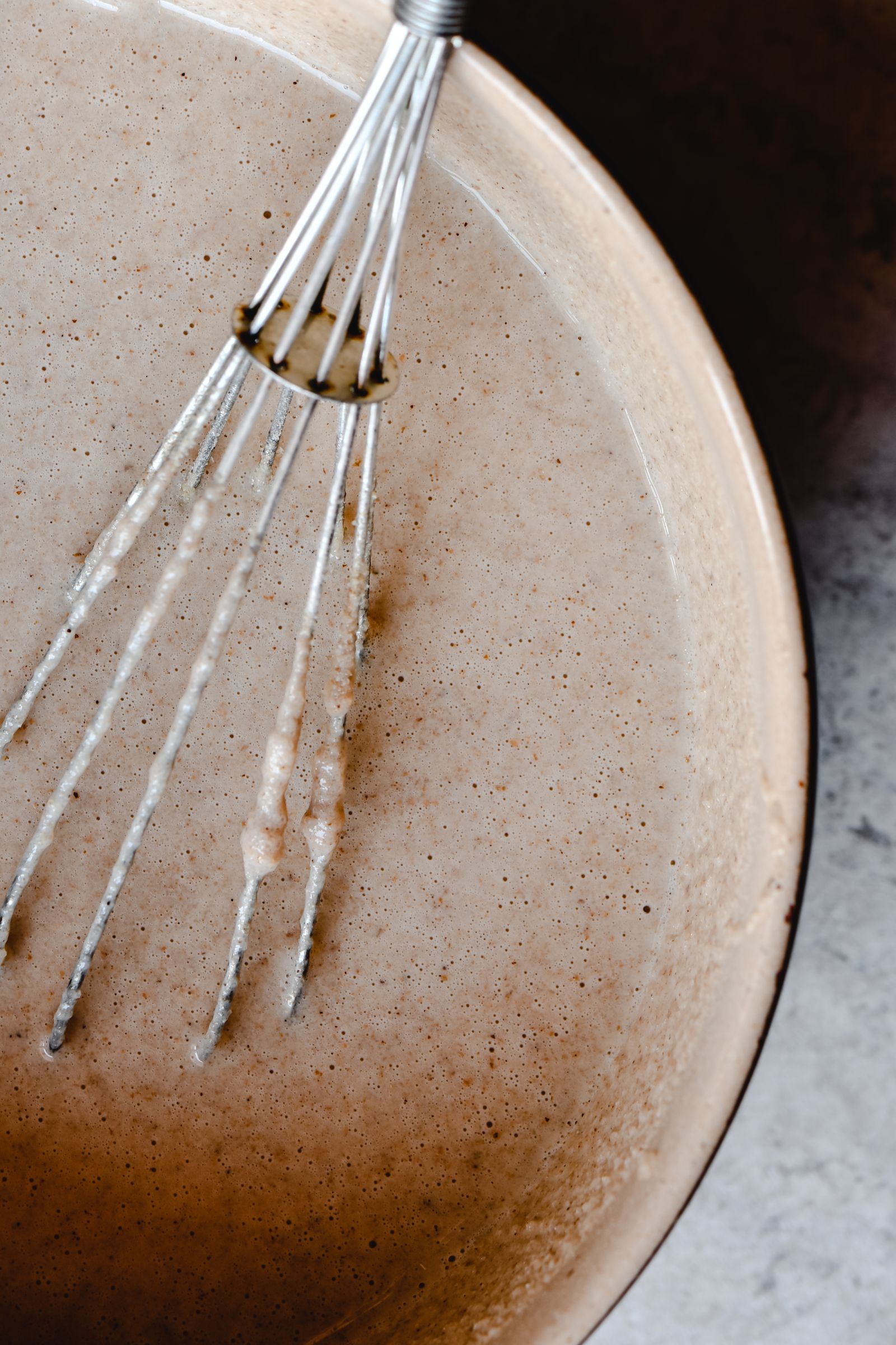 Whisking smooth pancake batter in a mixing bowl