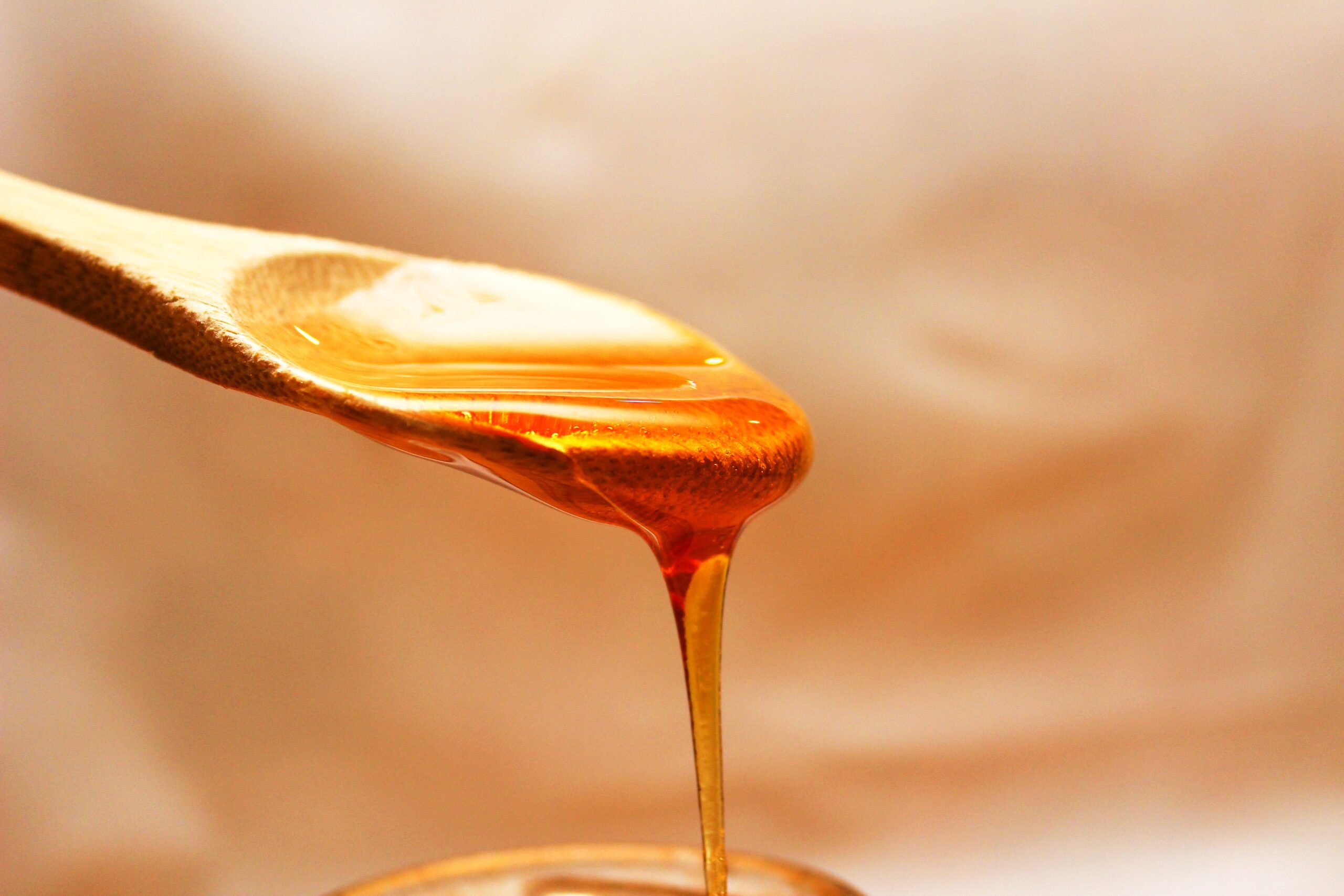 Honey pouring from a spoon for a salmon glaze