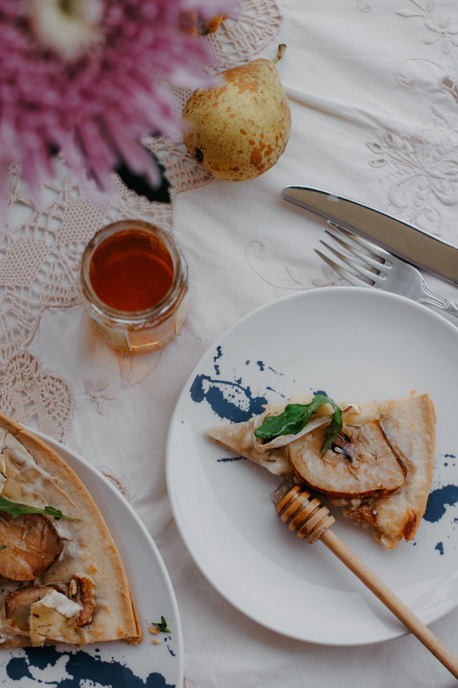 Slice of pear and cheese pizza drizzled with hot honey