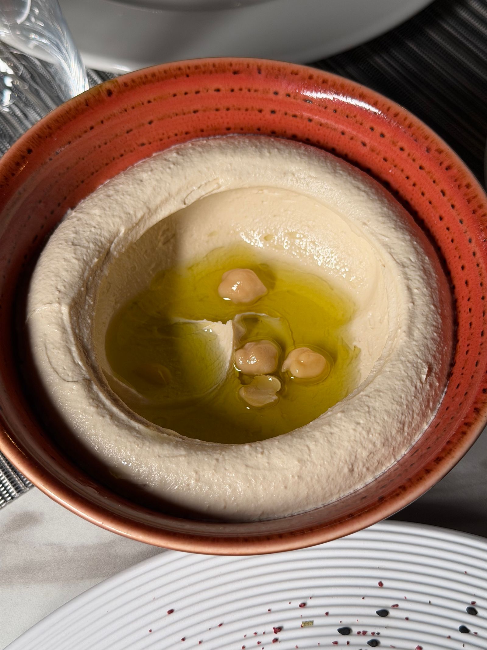 Delicious hummus dip garnished with olive oil and chickpeas