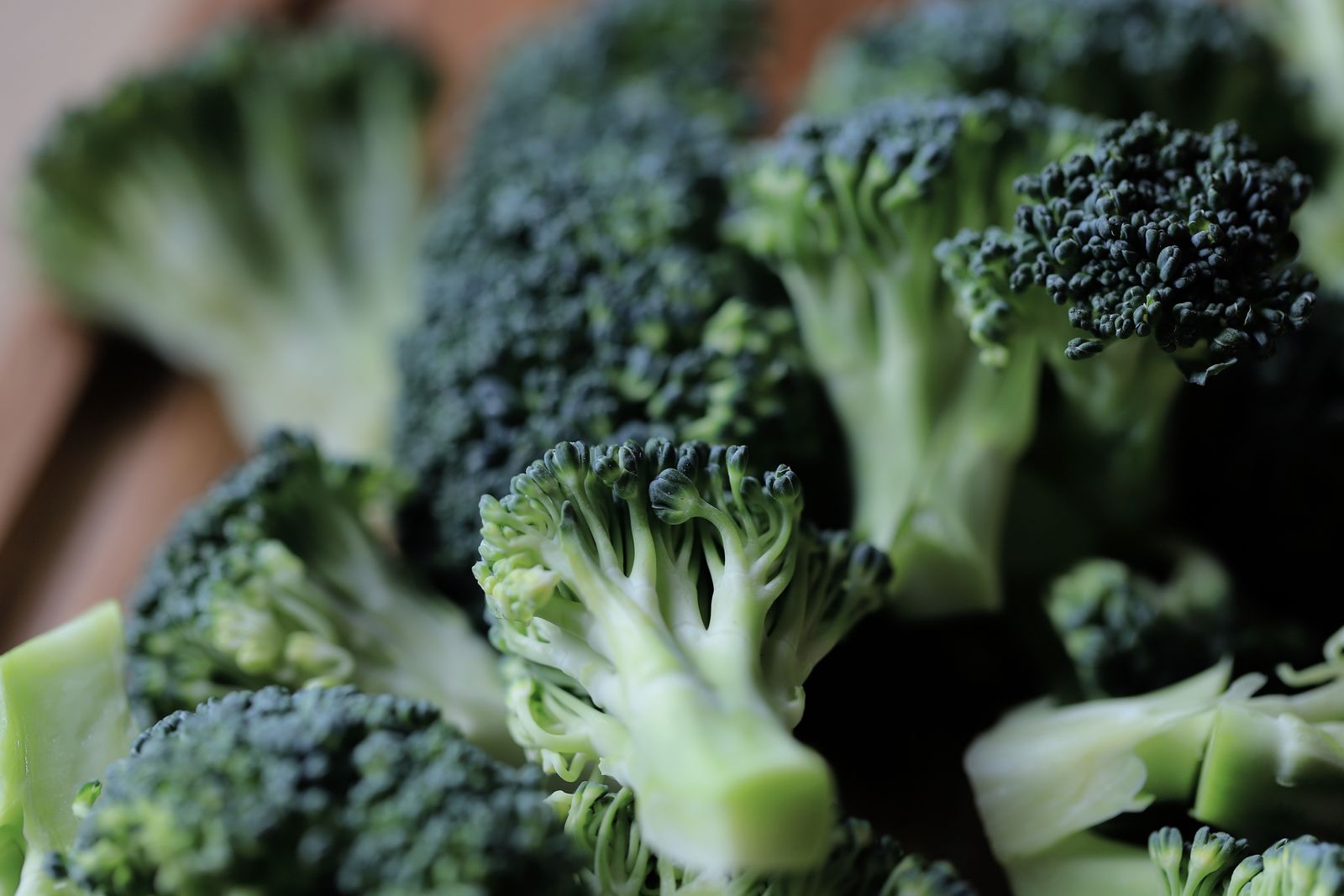 Close-up of fresh broccoli florets on a chopping board, ready for cooking